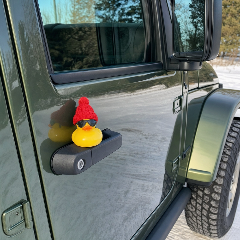 A rubber duck in a red beanie and sunglasses left on a Jeep door handle